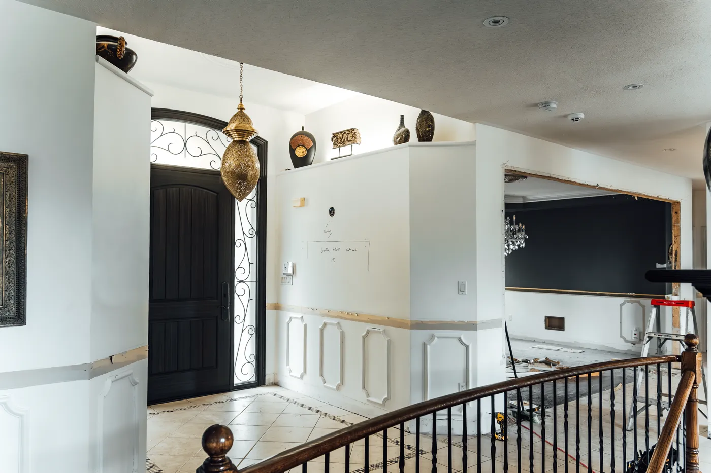 Custom foyer with black wrought-iron door, a Campoli build in Tottenham